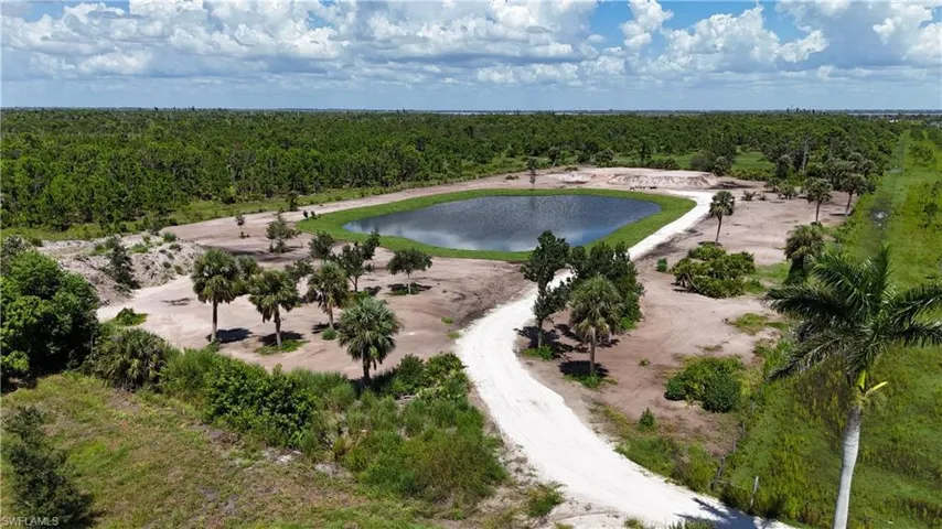 Aerial view of a heavily wooded area and a nearby body of water