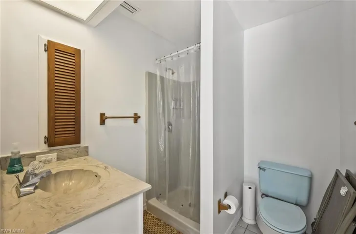 Bathroom featuring vanity, a shower stall, and light tile patterned floors