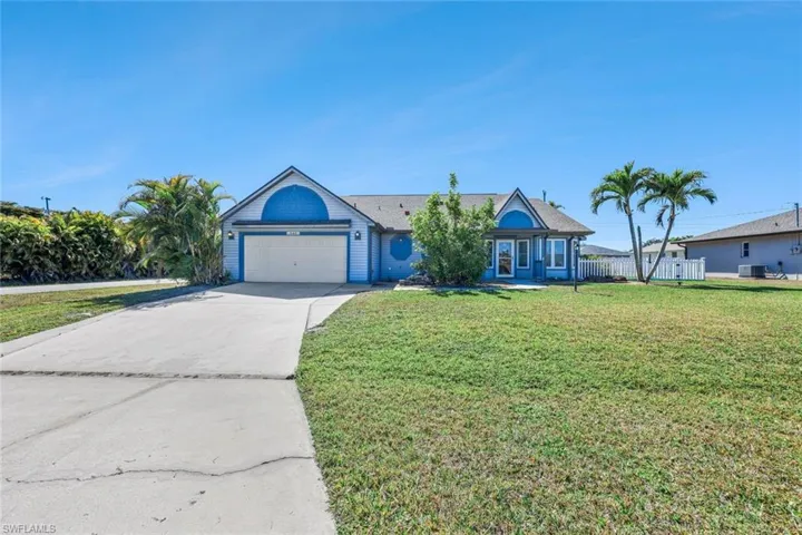 Single story home featuring concrete driveway and an attached garage