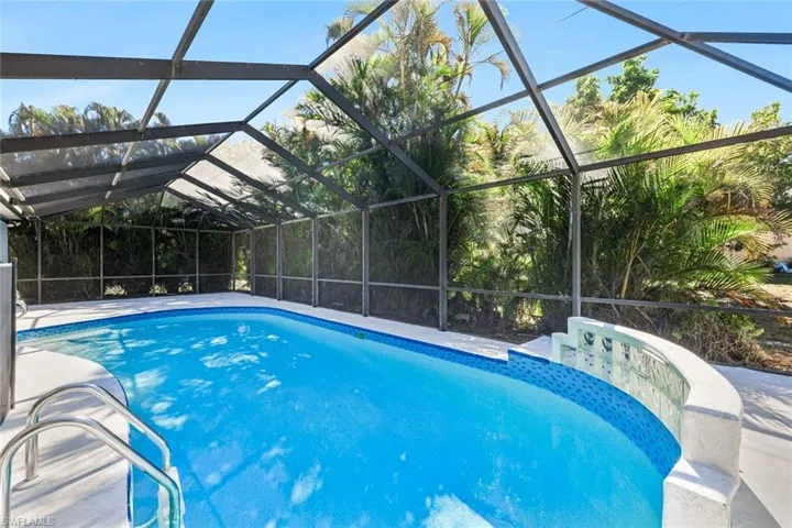 Swimming pool featuring a sunroom and a lanai