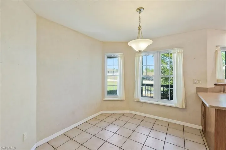 Unfurnished dining area with baseboards