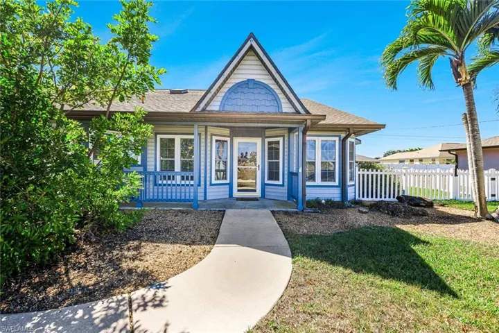 View of front of house featuring covered porch and a shingled roof