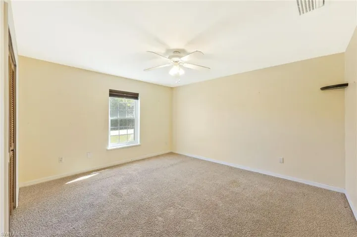 Unfurnished room with light carpet and ceiling fan