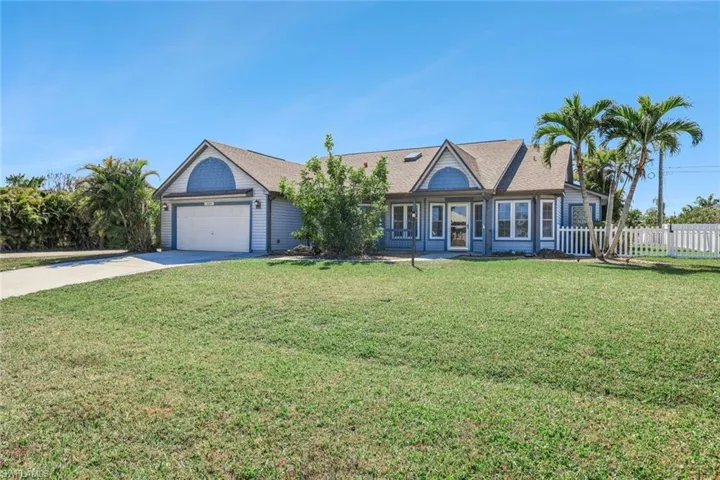 Single story home featuring concrete driveway, a garage, and roof with shingles