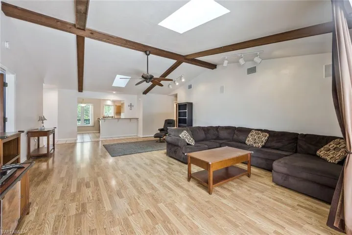 Living room featuring a skylight and light wood-type flooring