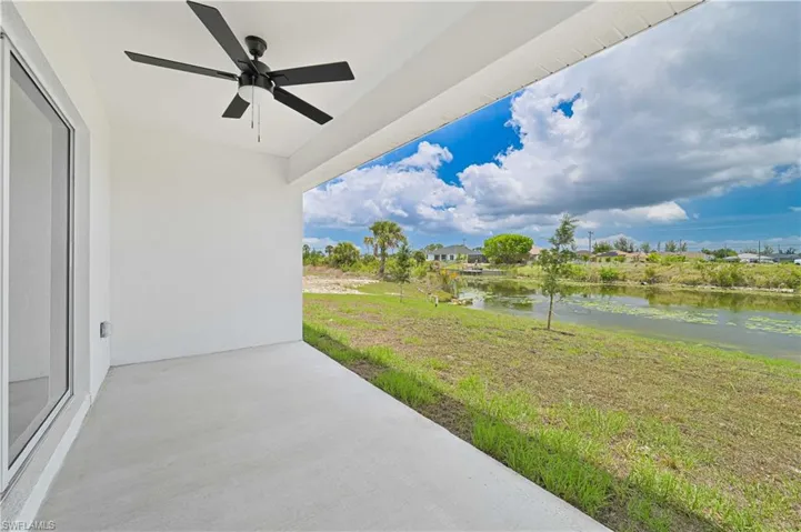 View of patio featuring a ceiling fan and a water view