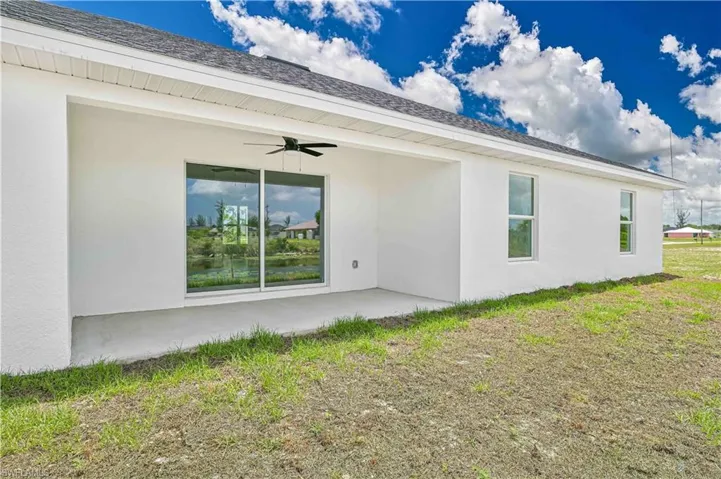 Back of house with a ceiling fan, a patio, and stucco siding
