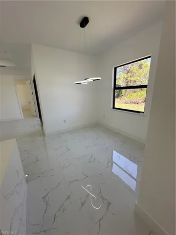 Unfurnished dining area featuring light marble finish floors