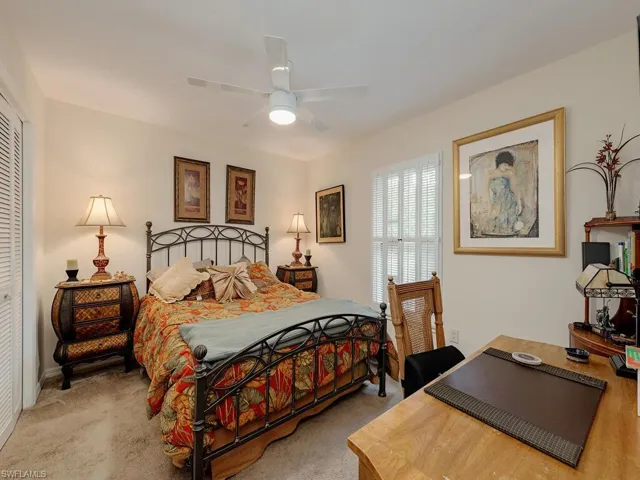 Carpeted bedroom with a closet and ceiling fan