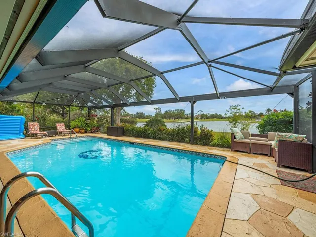 View of swimming pool featuring an outdoor living space, a lanai, and a patio area