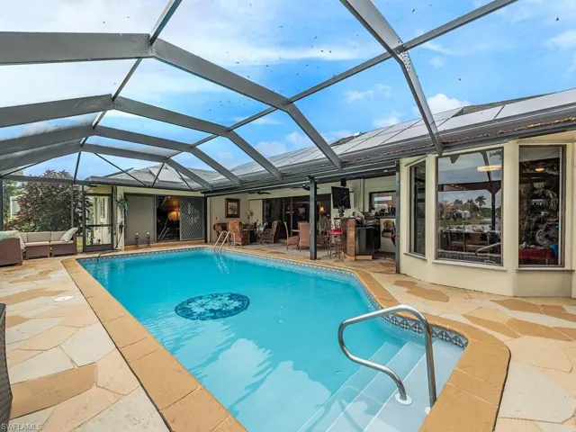 View of pool featuring outdoor lounge area, a patio area, and a lanai