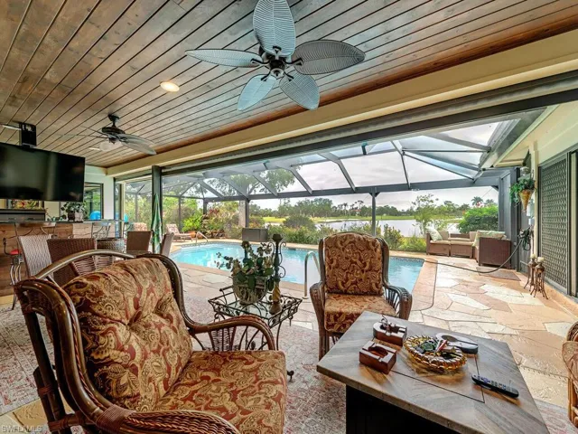 View of patio with an outdoor living space, ceiling fan, and a lanai