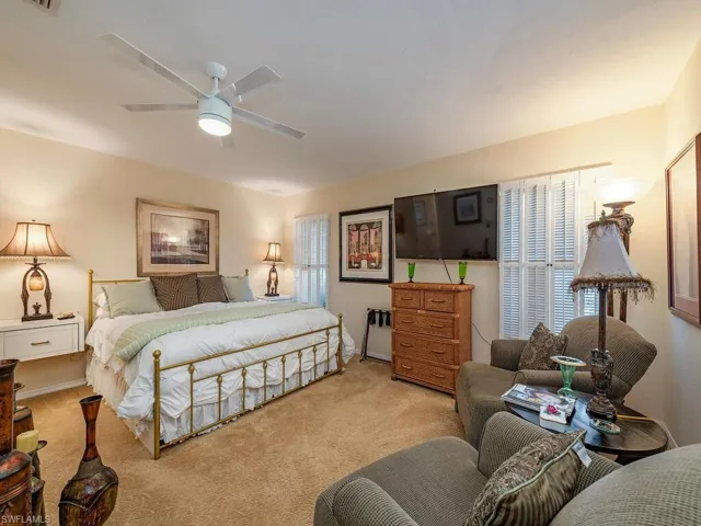 Carpeted bedroom with ceiling fan