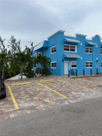 View of property featuring uncovered parking
