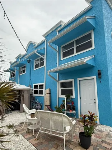 Rear view of house featuring stucco siding and a patio area