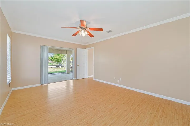 Spare room with ceiling fan, ornamental molding, and light hardwood / wood-style floors