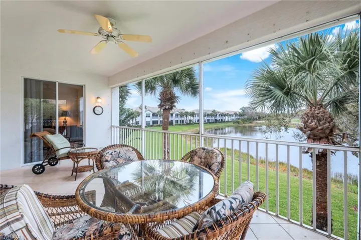 Sunroom featuring tile patterned flooring and a water view