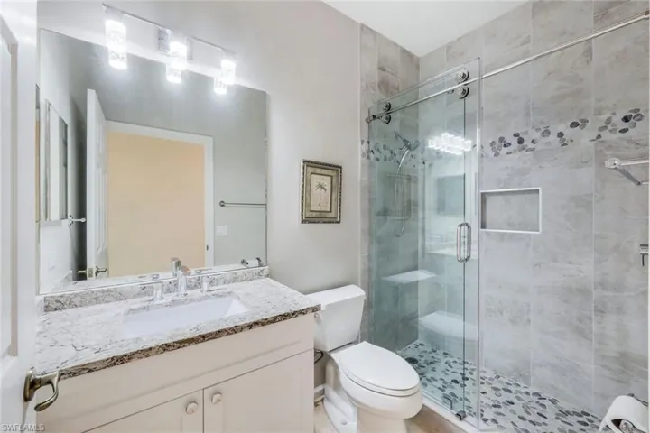 Bathroom with a stall shower and vanity