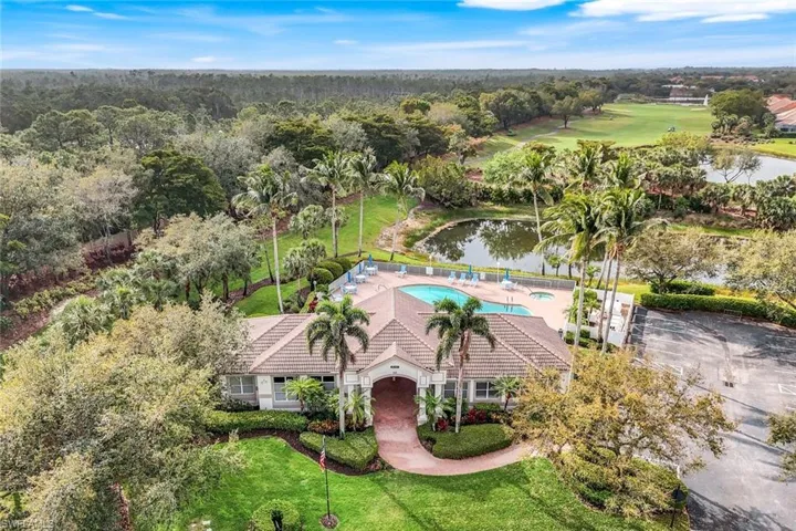 Aerial view of property's location with a nearby body of water and a pool area