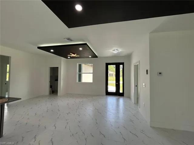 Entrance foyer featuring light marble finish floors and recessed lighting
