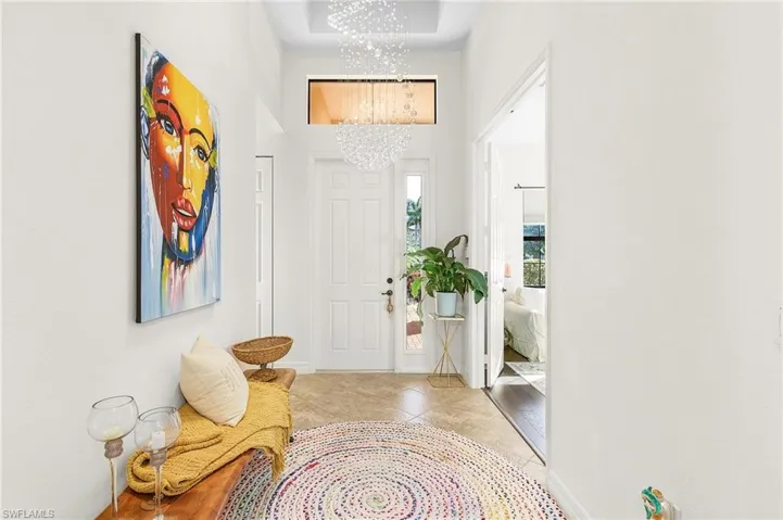 Entryway featuring a chandelier and light tile patterned flooring