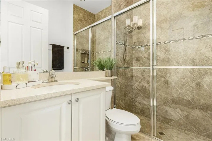 Bathroom with a stall shower and vanity