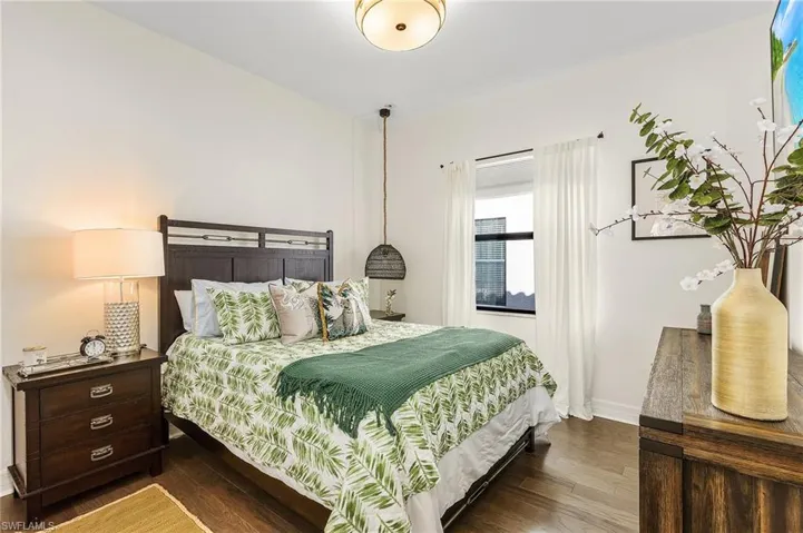 Bedroom with dark wood-type flooring