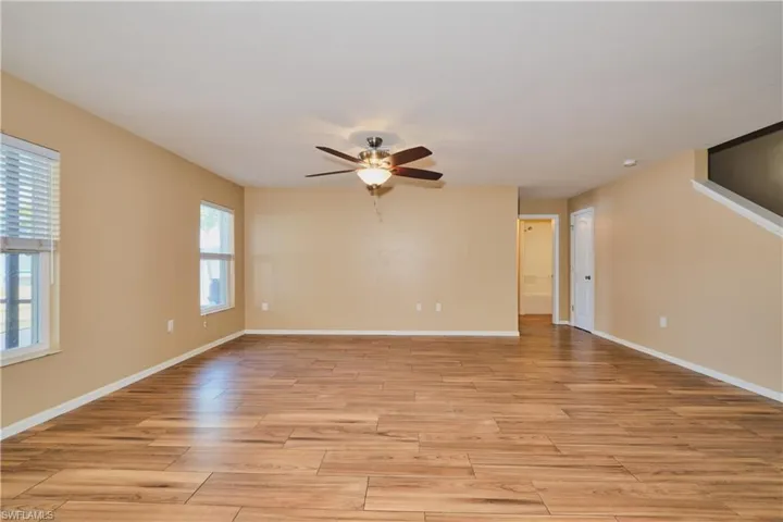 Empty room featuring light wood finished floors and a ceiling fan
