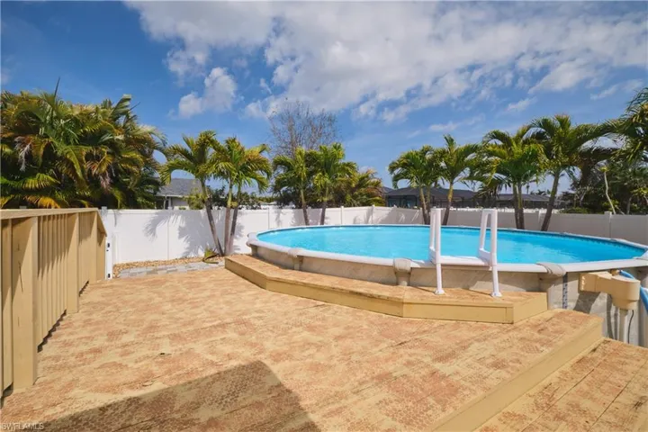View of swimming pool with a fenced backyard and patio surround