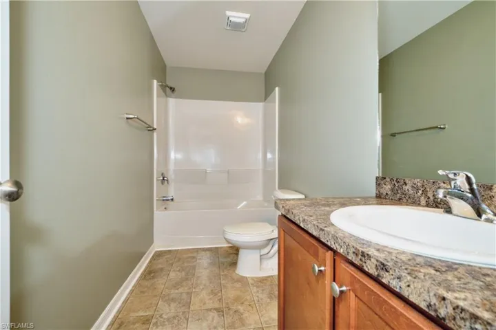Bathroom with vanity and shower / washtub combination
