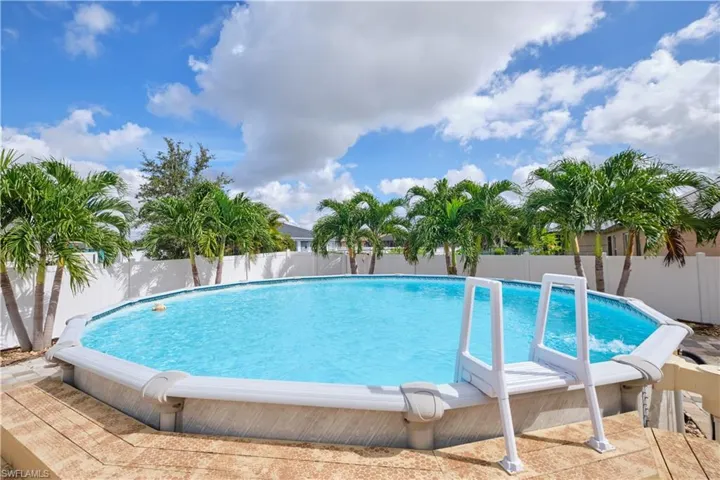 View of pool featuring a fenced backyard and patio surround