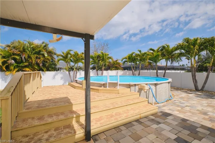 View of swimming pool with a fenced backyard and patio surround