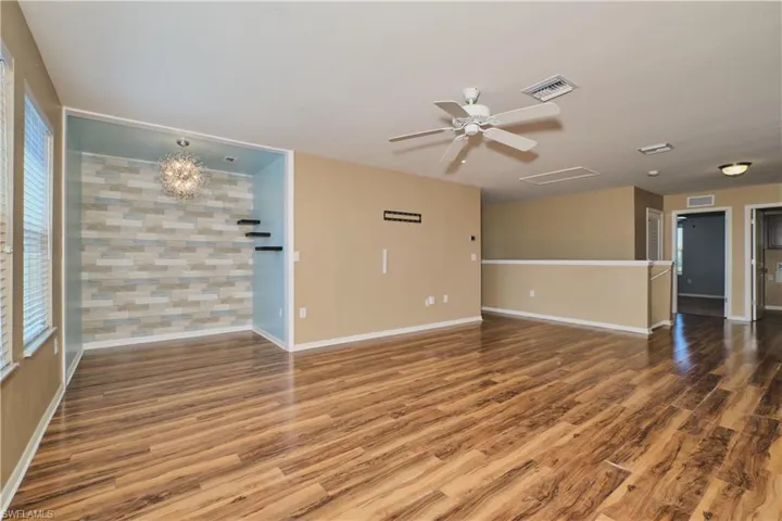 Spare room with dark wood-style floors and ceiling fan