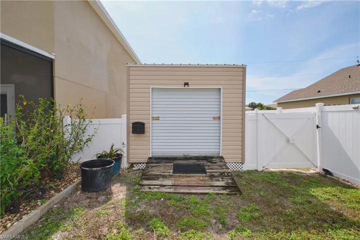 View of shed with a gate and a fenced backyard