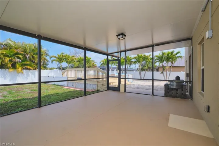 Unfurnished sunroom with healthy amount of natural light and a patio