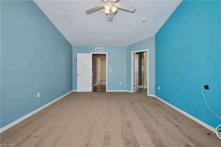 Unfurnished bedroom featuring carpet and ceiling fan