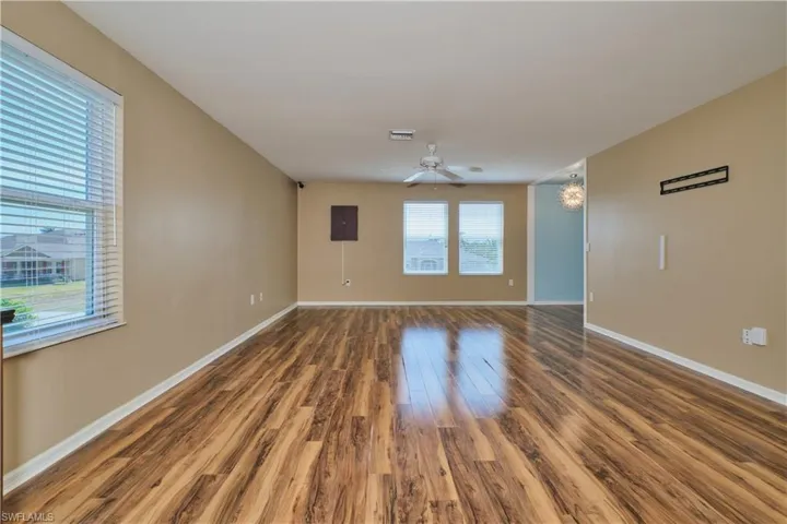 Unfurnished room with wood finished floors and a ceiling fan