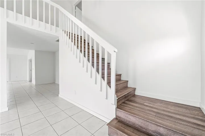 Stairs with a towering ceiling and new LVT stairs flooring