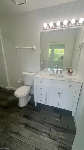 Bonus room / In-law suite bathroom featuring tiled / wood-style floors, updated vanity