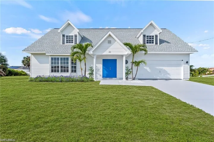 Cape Cod style house with a front yard