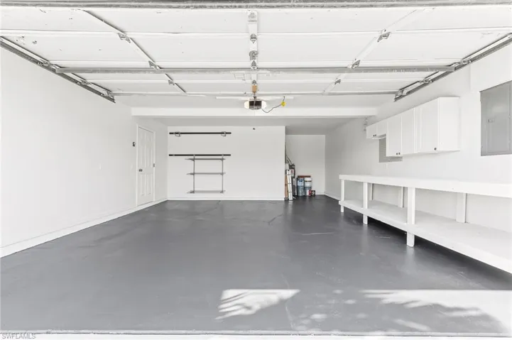 Automatic garage, newly painted flooring, workbench & cabinets