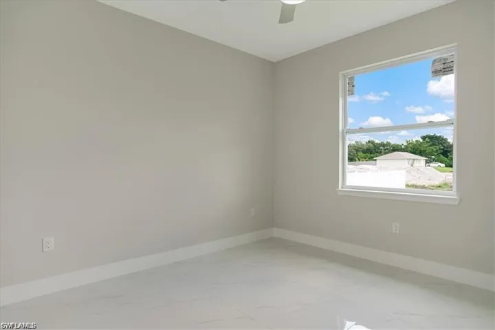 Unfurnished room featuring ceiling fan