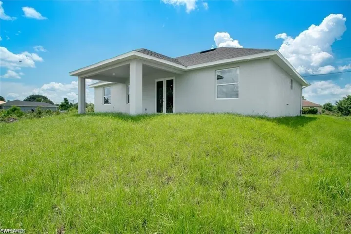 Rear view of property featuring a yard