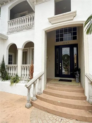 Doorway to property with stucco siding