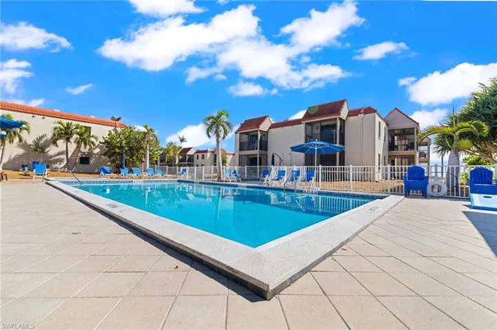 Community pool with a patio