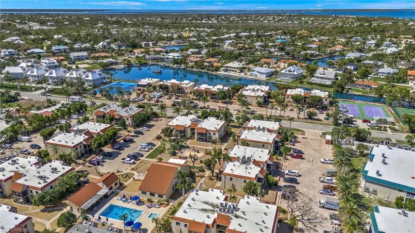Aerial view of residential area featuring a nearby body of water