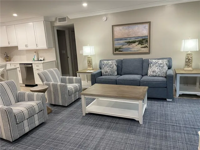 Living room with ornamental molding and recessed lighting