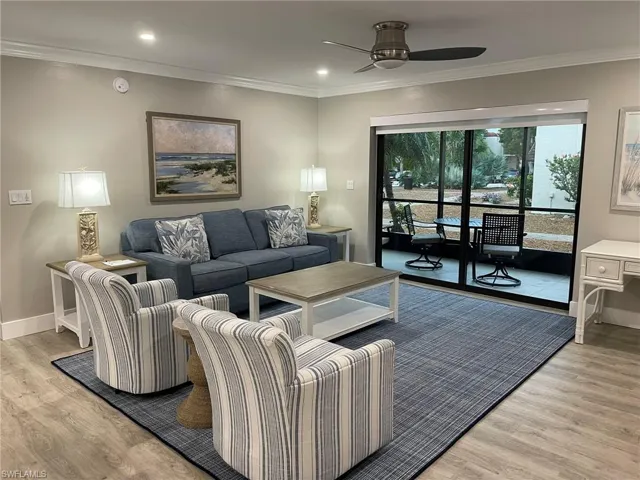 Living area featuring crown molding, light wood finished floors, recessed lighting, and ceiling fan