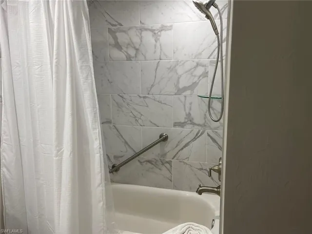 Bathroom featuring shower / bath combo with shower curtain