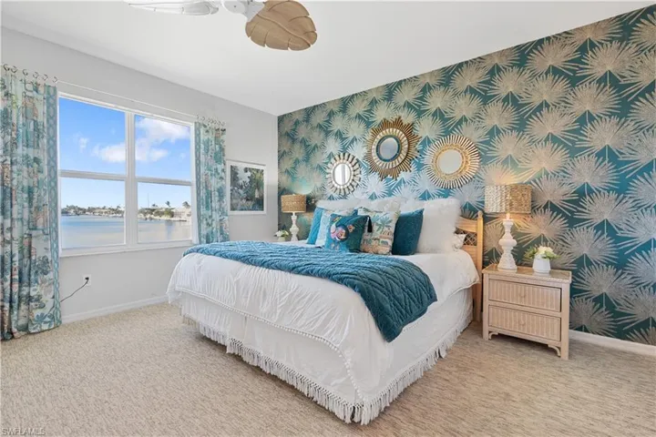 Bedroom featuring a water view and carpet flooring